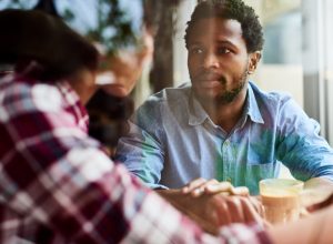shot of an affectionate young couple having a discussion about something on their date at a coffee shop