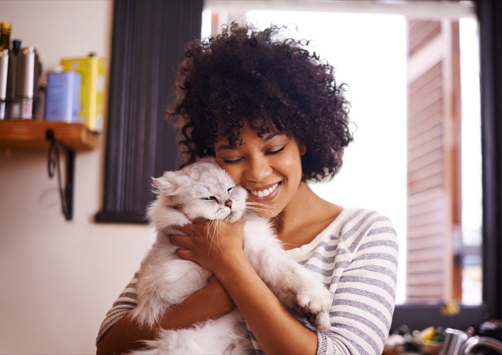 shot of a beautiful young woman enjoying a cuddle with her cat