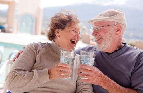 Happy older couple drinking water together