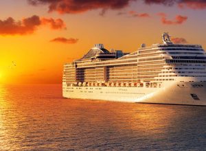cruise ship sailing into the sunset