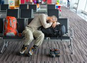 man sleeping at the boarding gate