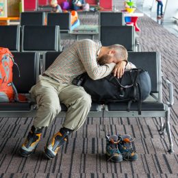 man sleeping at the boarding gate