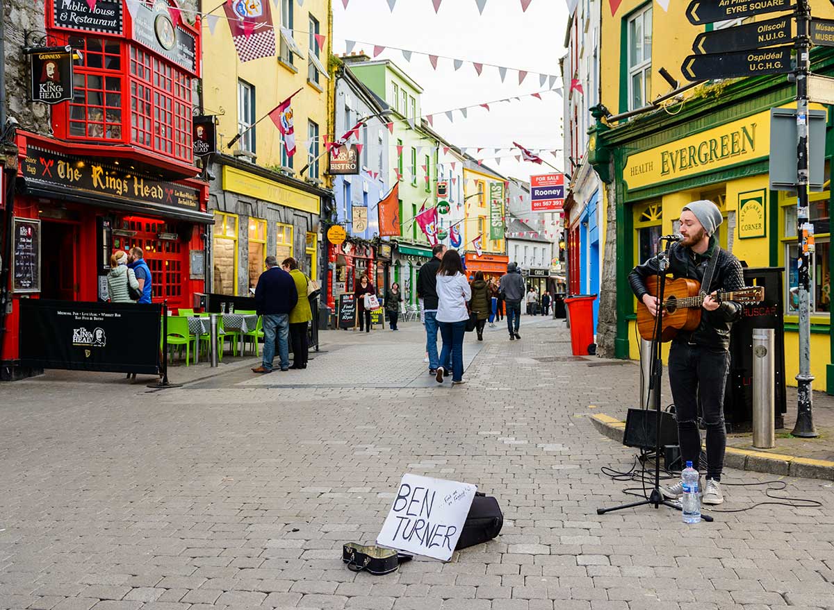 a musician plays on a street in ireland