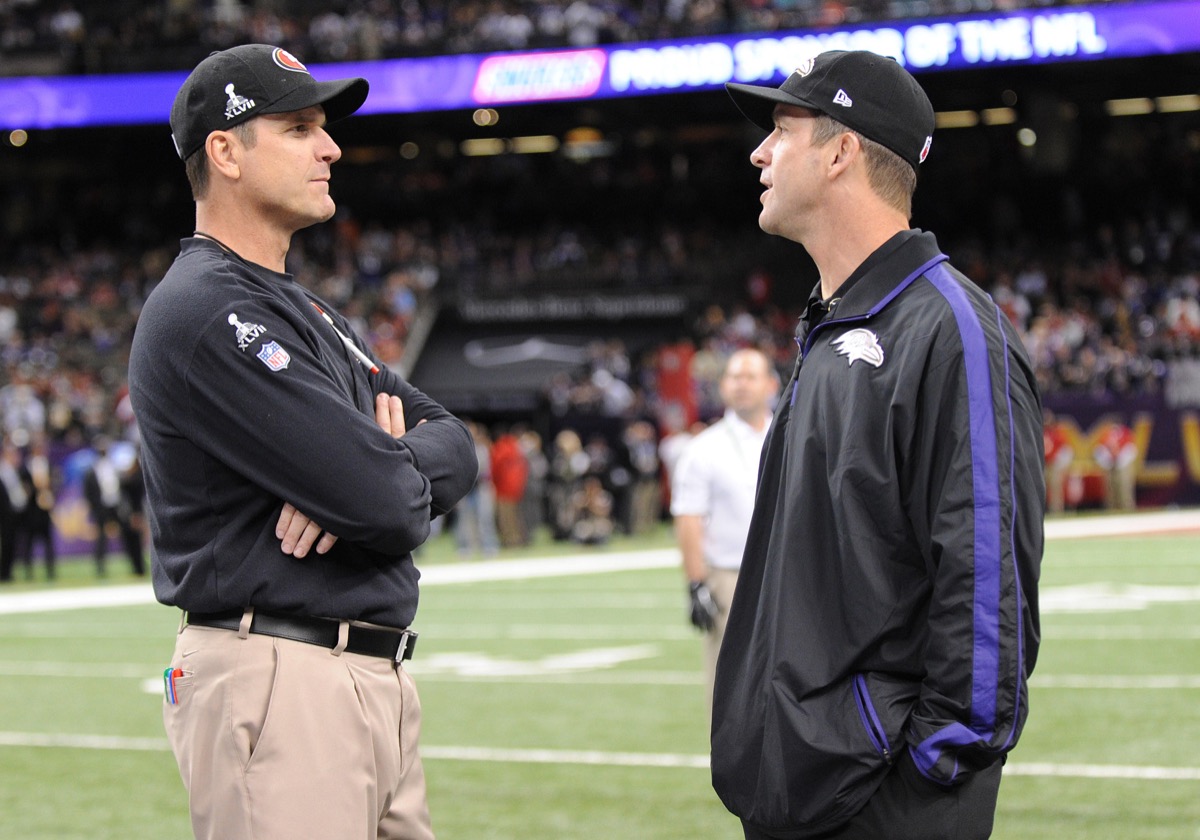 San Francisco 49ers head coach Jim Harbaugh and John Harbaugh talk before Super Bowl XLVII at the Mercedes-Benz Superdome on Feb. 3, 2013 in New Orleans.