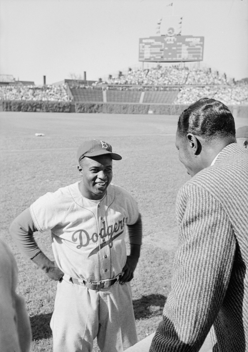 Jackie Robinson talking with Nat King Cole on the field