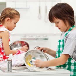 Kids sad while doing chores washing dishes together