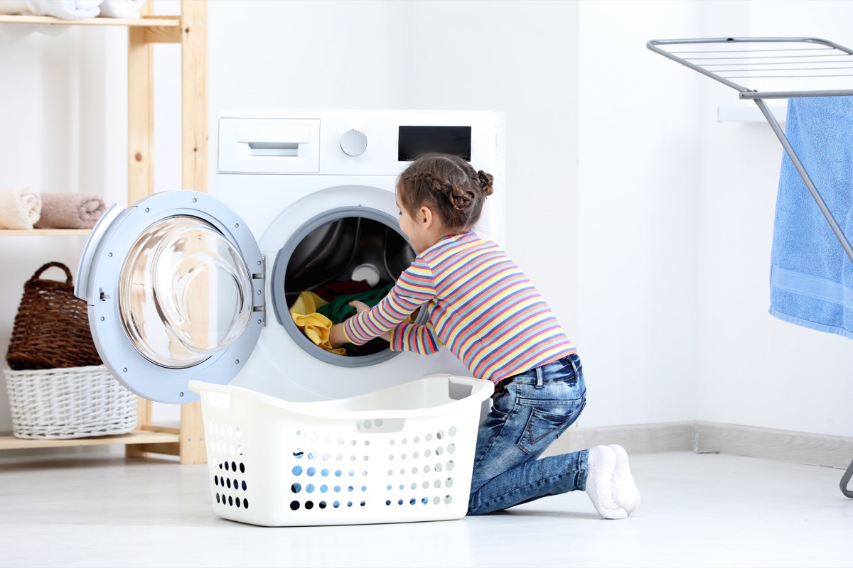 Young girl doing her chores laundry