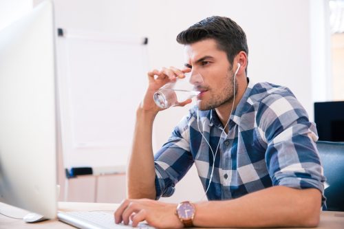 Man drinking water at work