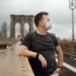 Man wearing a mask on dreary day in new york city