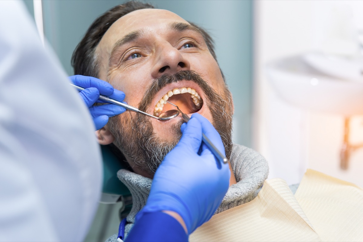 Man getting his teeth and gums checked out at the dentist