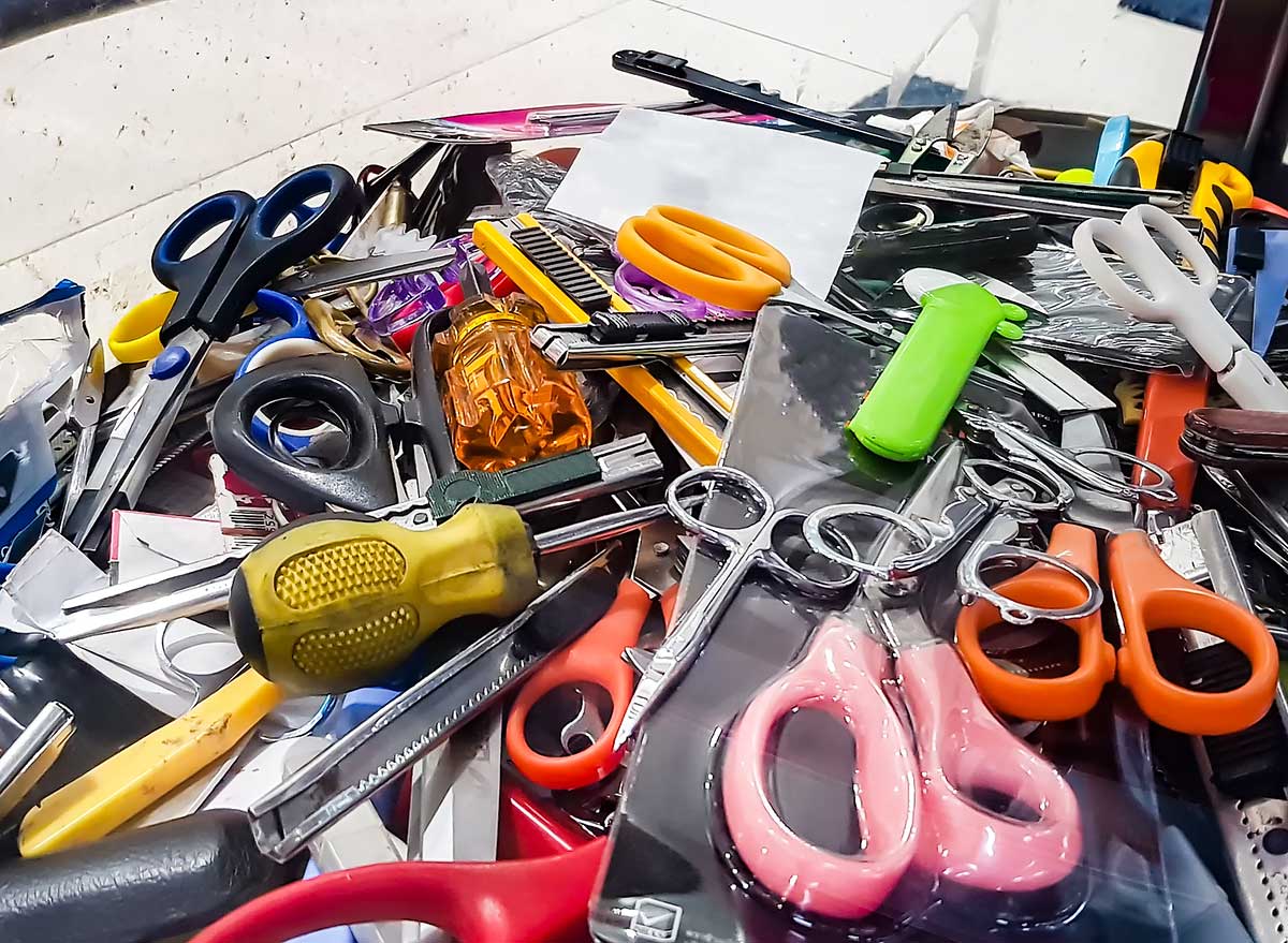 scissors, screwdrivers, and other prohibited items in a bin