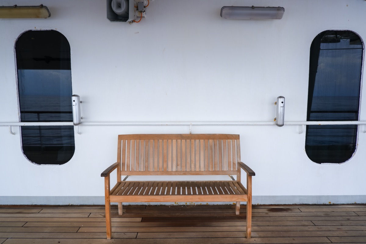 wood bench near the designated smoking area on a cruise