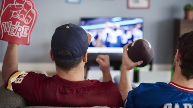 Two men watching the Super Bowl on TV