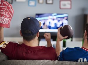 Two men watching the Super Bowl on TV
