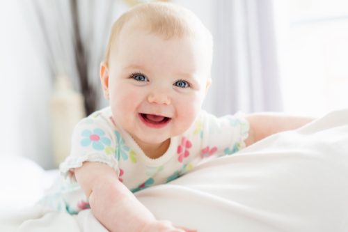 white baby with red hair smiling