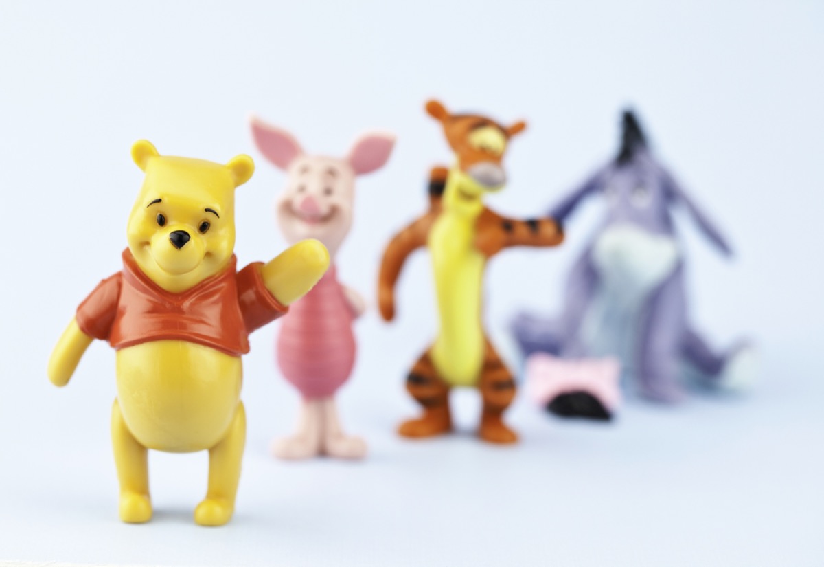 Suffolk, Virginia, USA - April 30, 2011: A horizontal studio shot of the fictional cartoon characters Winnie the Pooh, Piglet, Tigger and Eeyore. Here Winnie the Pooh is standing in the foreground waving and is the focal point of the image, while the other characters are defocused in the background.