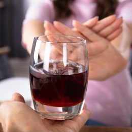 woman saying no to an alcoholic drink