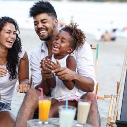 Young family laughing on beach