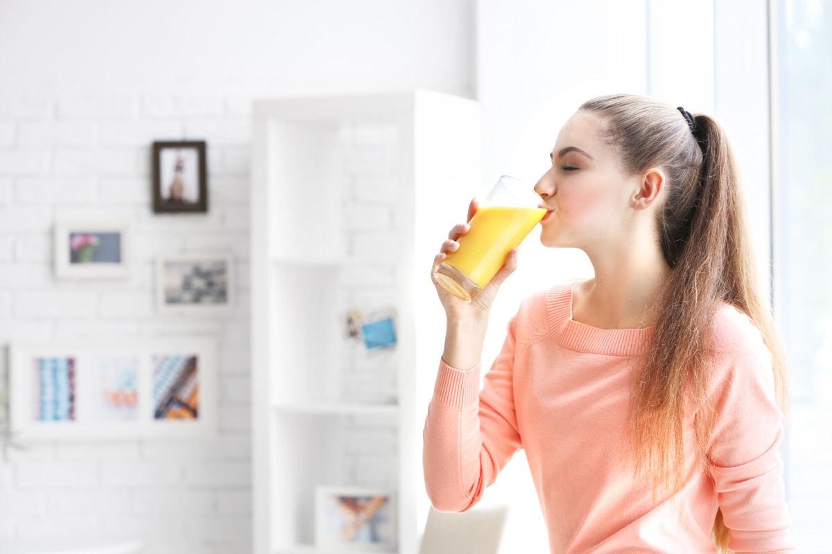 young woman drinking juice