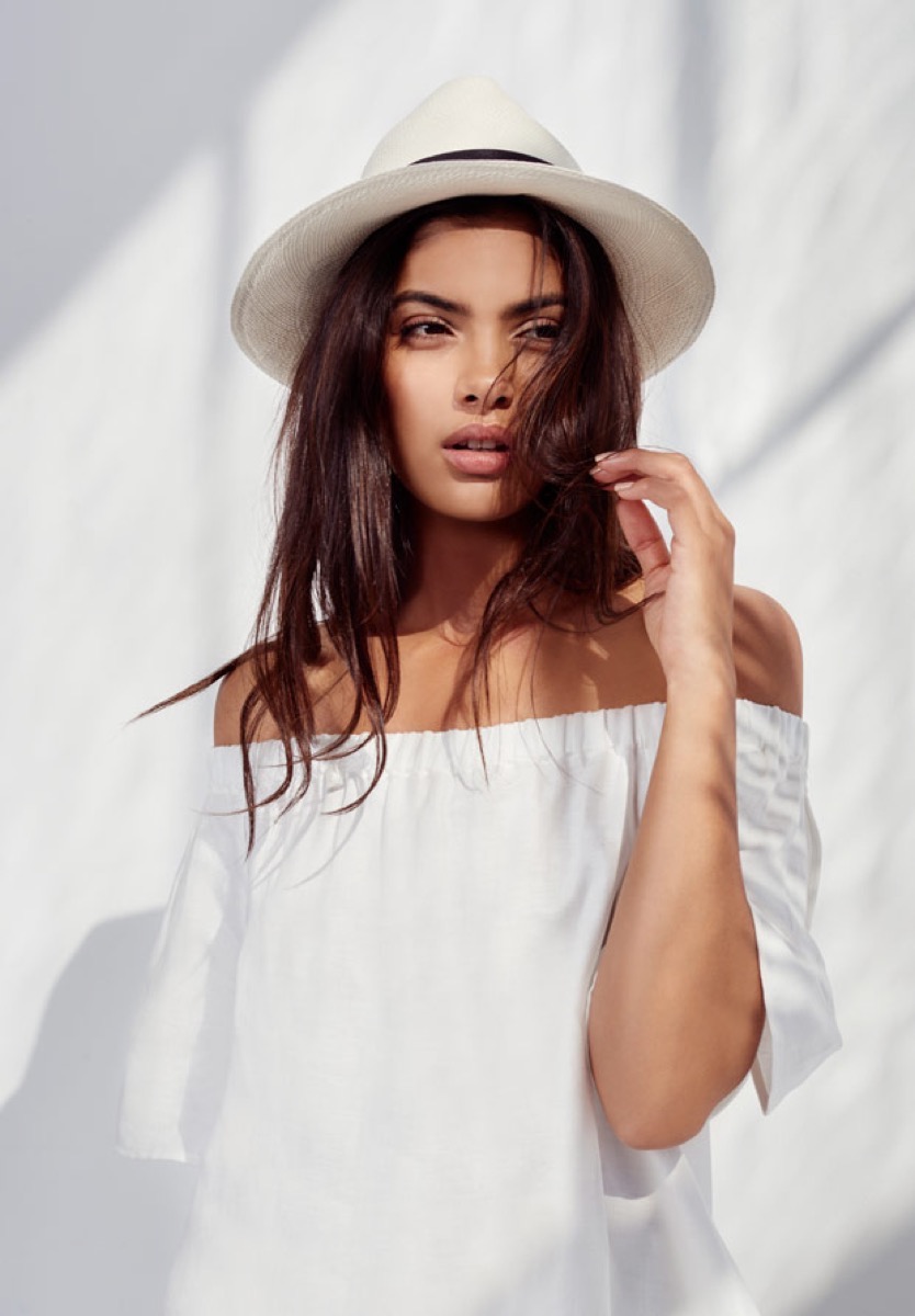 hispanic woman in white shirt and white hat