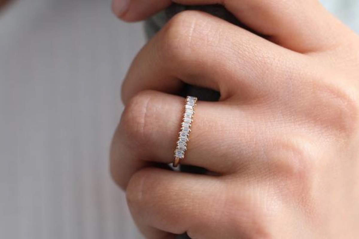 white hand wearing diamond ring