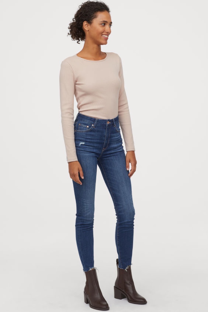 black woman in jeans and tan top