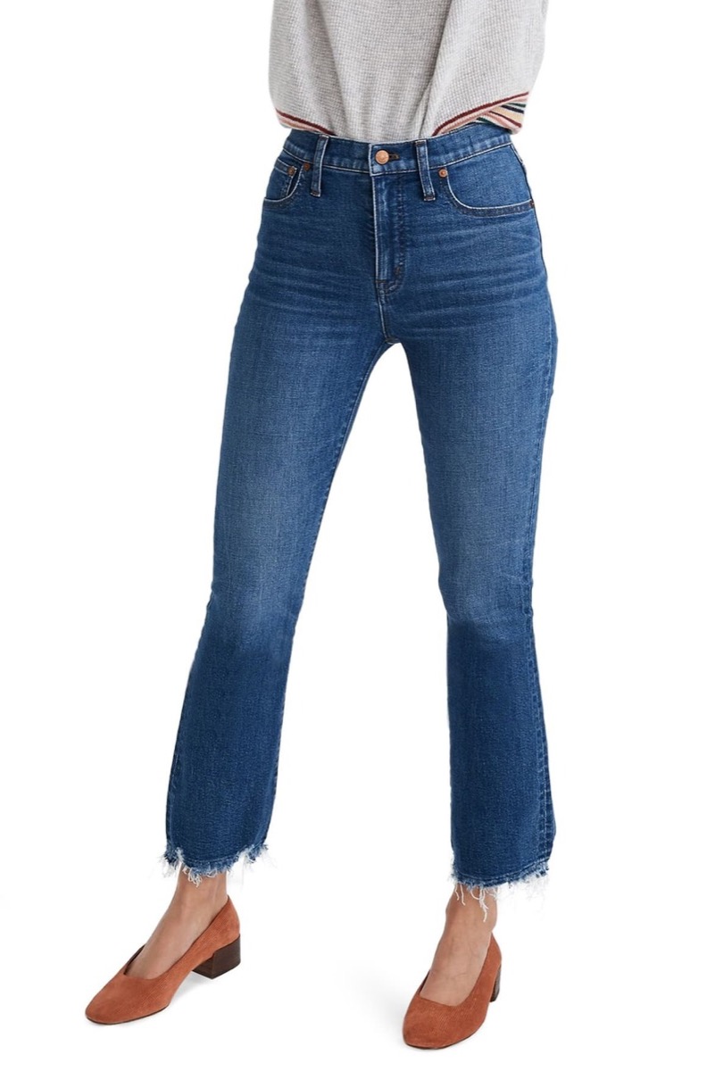 Woman wearing demi bootcut fringe jeans