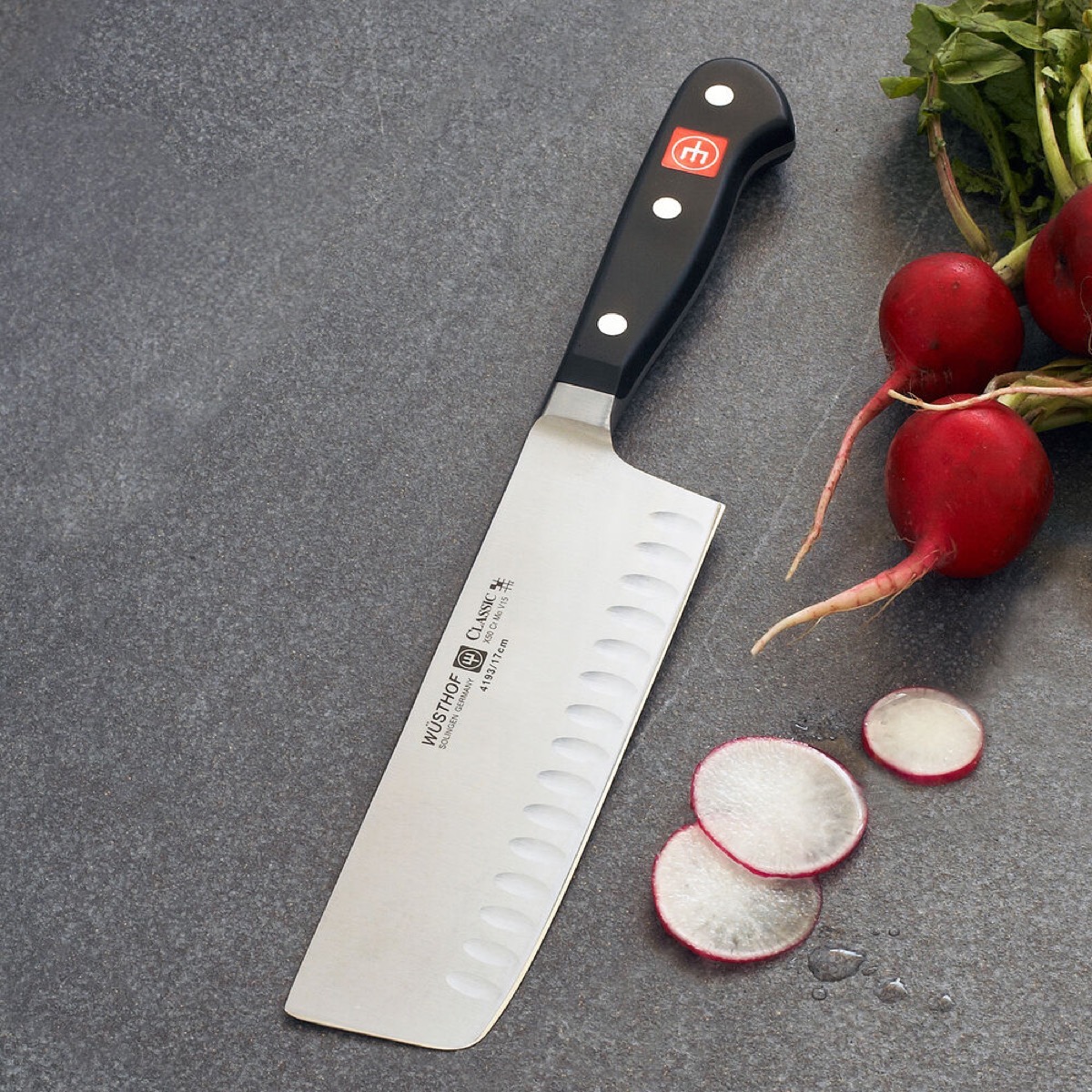 large knife next to chopped radish