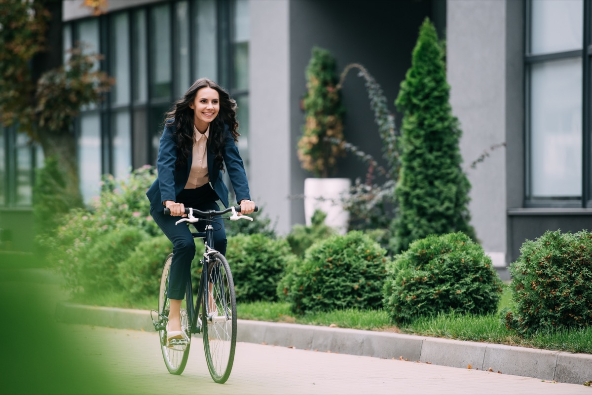 Business woman riding her bike to work