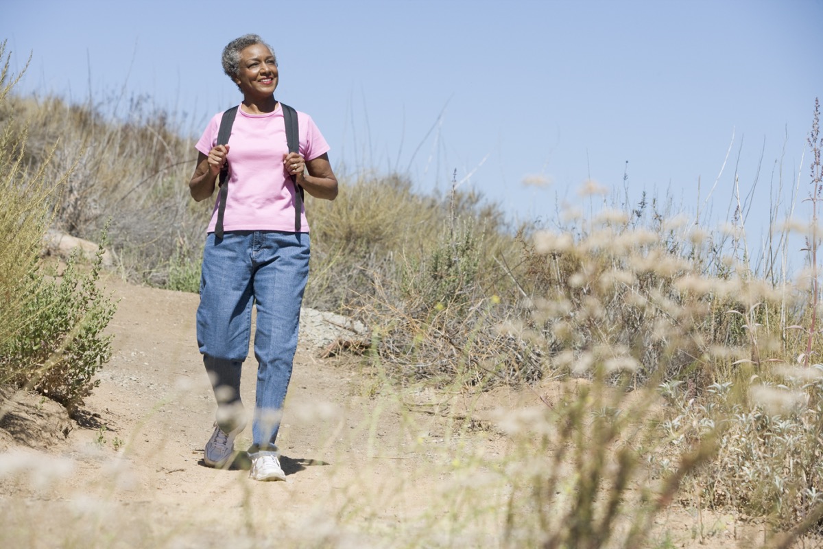 Black woman walking outside on a hike
