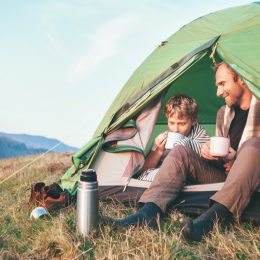 Father son camping in tent