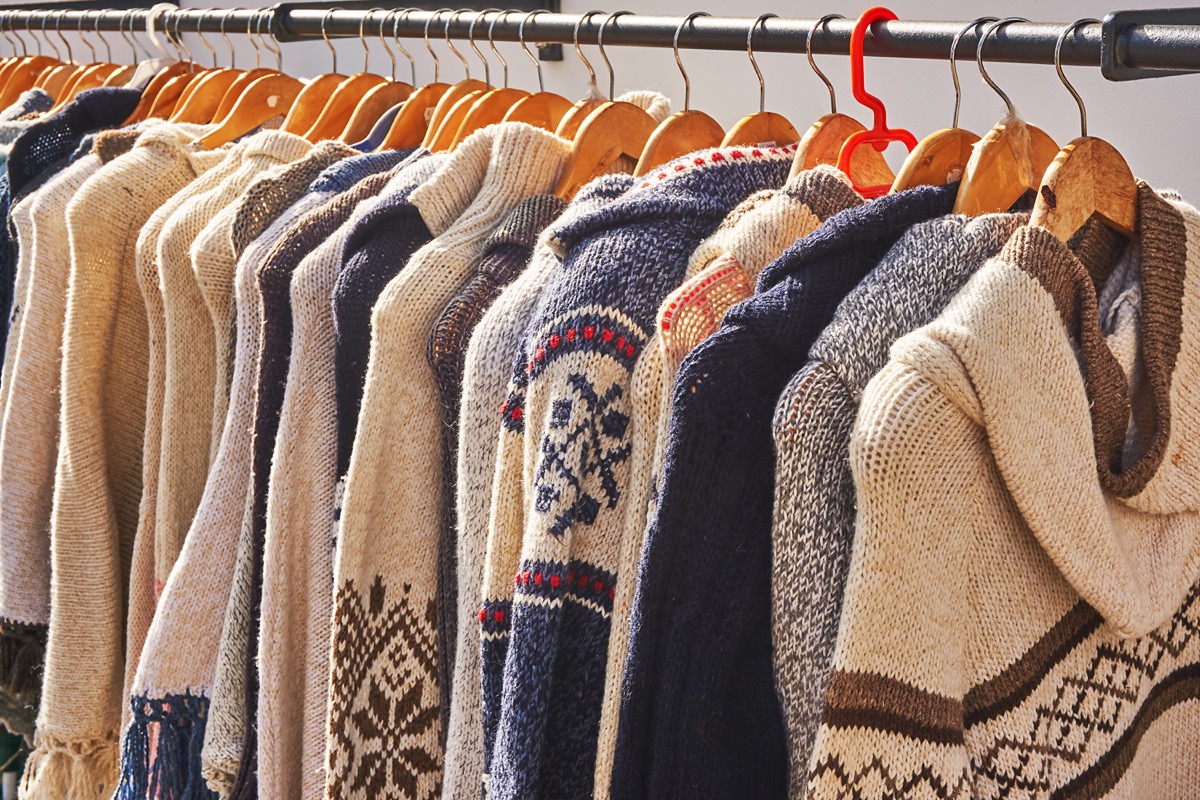 rack of cardigans hung up next to each other