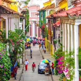 Street in walled city in Cartagena Colombia with people walking