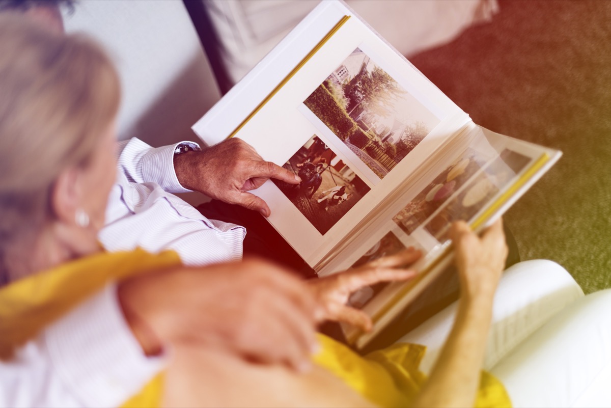 older white couple looking at photo album