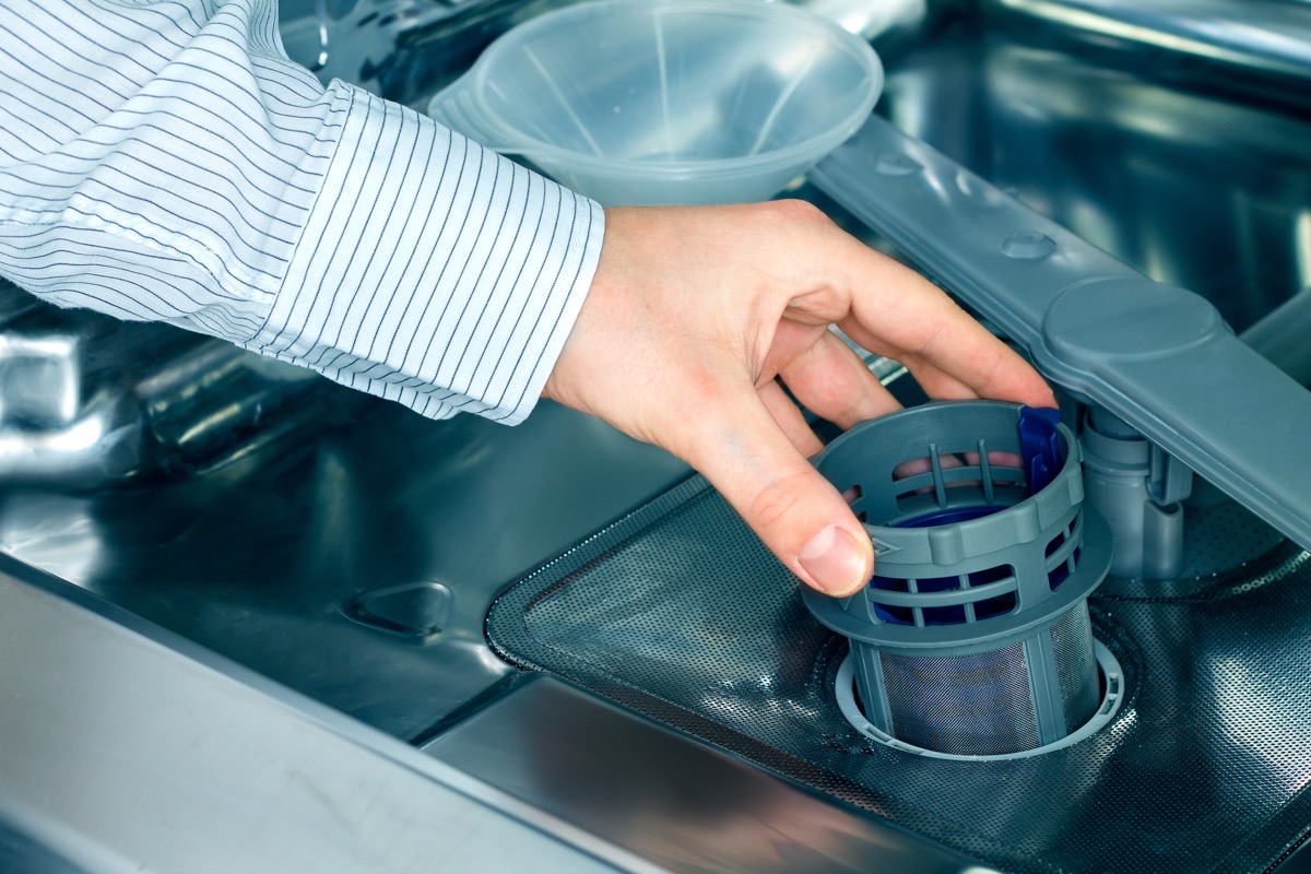 Man taking out a dishwasher filter