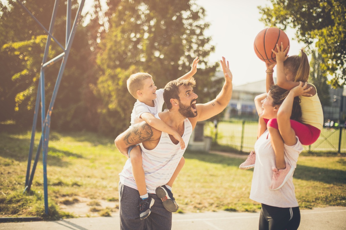 Family playing basketball together