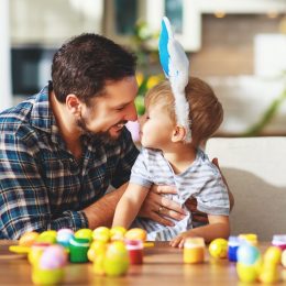Father and son dyeing Easter eggs