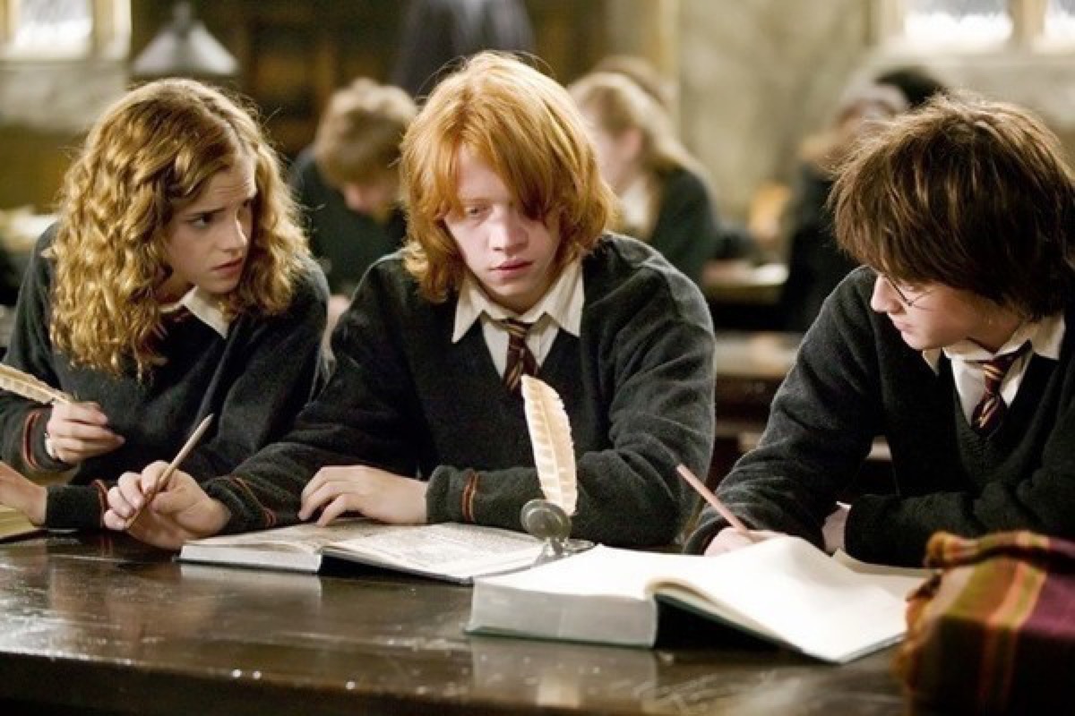 Harry Ron and Hermione taking an exam in Harry Potter