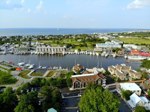The aerial view of the beach town, fishing port and waterfront residential homes along the canal Lewes Delaware