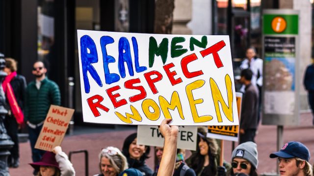 sign that reads "real men respect women" at women's march