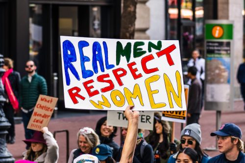 sign that reads "real men respect women" at women's march