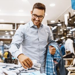30-something white man in glasses shopping for clothing