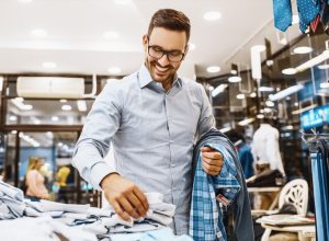 30-something white man in glasses shopping for clothing