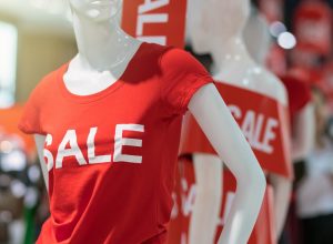 mannequin in red t-shirt with "sale" on it