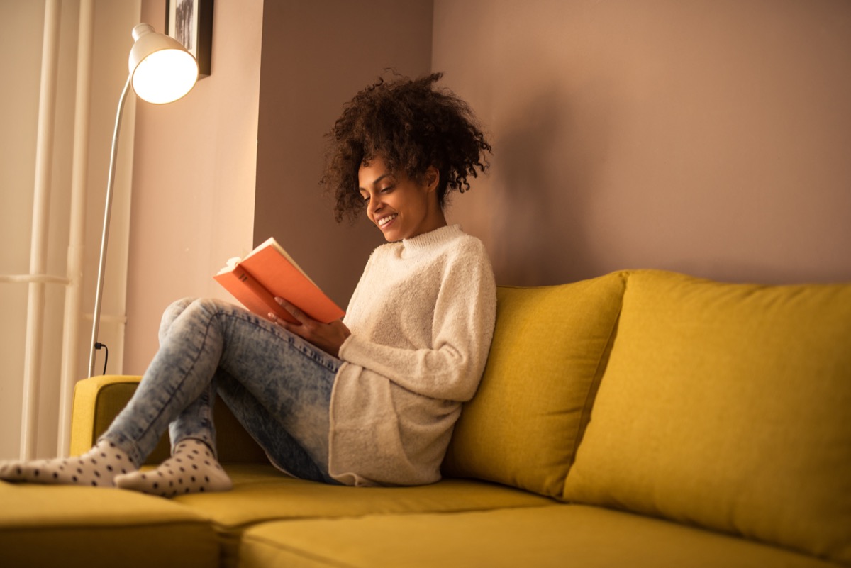 Woman reading a book on the couch