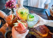 group of friends clinking mocktails, low-alcohol drinks
