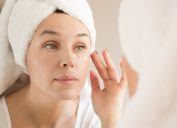 middle-aged white woman applying eye cream