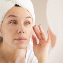 middle-aged white woman applying eye cream