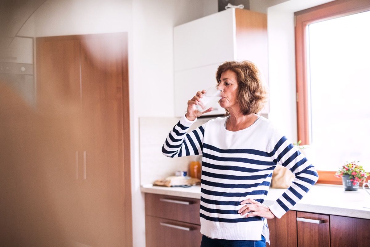 Older woman drinking water