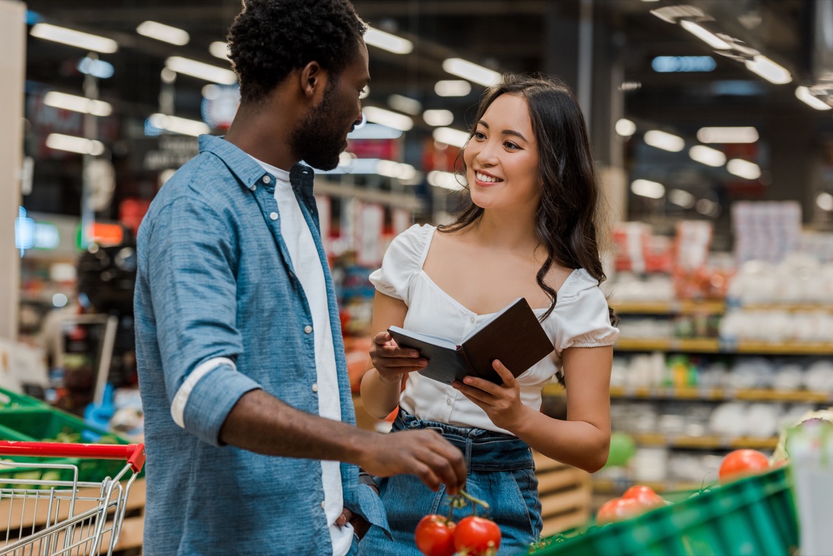 young black man talking to asian woman in grocery store